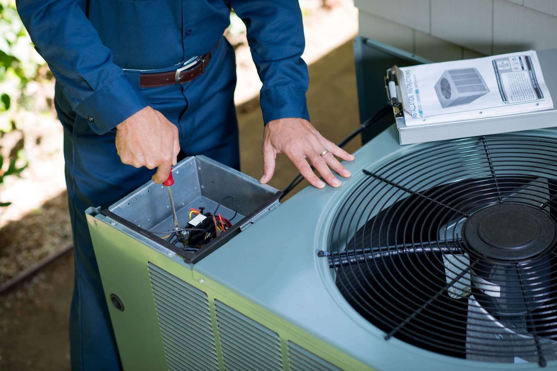 HVAC Technicains inspecing HVAC unit in Texas