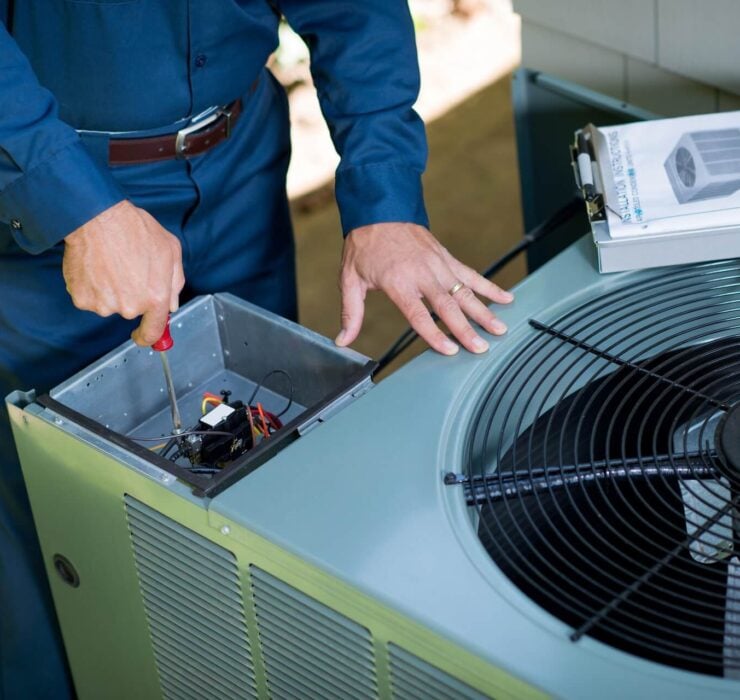 HVAC Technicains inspecing HVAC unit in Texas
